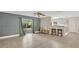 Open-concept living room with sliding glass doors leading to outdoor space and modern flooring at 88 Valencia Dr, Ormond Beach, FL 32176