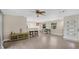Bright living room with wood floors, ceiling fan, and bar seating connecting to kitchen at 88 Valencia Dr, Ormond Beach, FL 32176