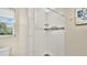 Modern shower with subway tile, mosaic accents, and a glass door next to the toilet at 88 Valencia Dr, Ormond Beach, FL 32176