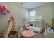 Playful bedroom with a teepee, unique bed, and plenty of natural light at 887 Lake Hill Way, Deland, FL 32724