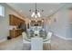 Open dining area with a glass table and modern chairs, next to the kitchen island at 887 Lake Hill Way, Deland, FL 32724