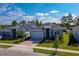 Exterior of a modern home featuring a well-manicured lawn, a paved driveway, and beautiful landscaping under a blue sky at 887 Lake Hill Way, Deland, FL 32724