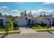 A well-maintained home with a landscaped front yard and modern architectural elements set against a bright, cloudy sky at 887 Lake Hill Way, Deland, FL 32724