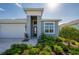 Beautiful home with a manicured front yard, stylish entry, and brick paver walkway at 887 Lake Hill Way, Deland, FL 32724