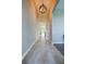 Long hallway with high ceiling and modern light fixture, connecting various rooms throughout the house at 887 Lake Hill Way, Deland, FL 32724