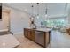 Stylish kitchen island featuring stainless steel appliances and seamless design to the living room at 887 Lake Hill Way, Deland, FL 32724