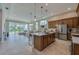 Open kitchen with a central island, modern pendant lighting, and seamless flow to the living area at 887 Lake Hill Way, Deland, FL 32724