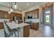 A modern, gourmet kitchen with a large island and barstool seating, stainless steel appliances, and stylish pendant lighting at 887 Lake Hill Way, Deland, FL 32724