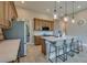 Spacious kitchen with a quartz counter island, stainless steel appliances, hanging lights, and gray bar stool seating at 887 Lake Hill Way, Deland, FL 32724
