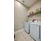 Bright laundry room featuring a front-loading washer and dryer, and overhead storage space at 887 Lake Hill Way, Deland, FL 32724