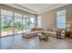 Inviting living room with a comfortable sectional, large windows, and access to the outdoor patio at 887 Lake Hill Way, Deland, FL 32724