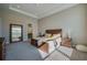 Spacious main bedroom with tray ceiling, carpet, and a decorative mirror at 887 Lake Hill Way, Deland, FL 32724