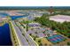 Aerial view of tennis and pickle ball courts with nearby community pool at 887 Lake Hill Way, Deland, FL 32724