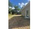 A backyard with dry grass and the side of a home at 926 Clover St, Deland, FL 32720
