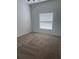 Empty bedroom with neutral carpet and a window bringing in light at 926 Clover St, Deland, FL 32720