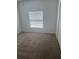 Empty bedroom with neutral carpet and closet and a window bringing in light at 926 Clover St, Deland, FL 32720