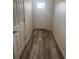 A home entryway with wood-look flooring and a white front door at 926 Clover St, Deland, FL 32720
