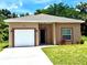 Inviting single-story home with a well-maintained lawn, one-car garage, and neutral-toned exterior at 926 Clover St, Deland, FL 32720