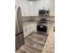 Well-equipped kitchen featuring stainless steel appliances, modern cabinetry, and granite countertops at 926 Clover St, Deland, FL 32720