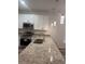 Bright kitchen showcasing granite countertops, modern appliances, and pendant lighting at 926 Clover St, Deland, FL 32720