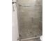 Modern bathroom shower with pebble tile floor and glass door at 926 Clover St, Deland, FL 32720