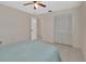 Bright bedroom featuring tile floors, ceiling fan, and double door closet at 1075 Burgoyne Rd, Deland, FL 32720