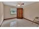 Spare bedroom featuring a ceiling fan, tile floors, and large wooden wardrobe at 1075 Burgoyne Rd, Deland, FL 32720