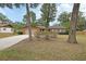 Charming one-story brick home featuring a large front yard with mature trees and a two-car garage at 1075 Burgoyne Rd, Deland, FL 32720