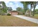 Brick home with attached two-car garage, long driveway and well-kept lawn at 1075 Burgoyne Rd, Deland, FL 32720