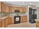 Kitchen features light wood cabinets, tile countertops, and stainless microwave at 1075 Burgoyne Rd, Deland, FL 32720