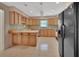 Kitchen features light wood cabinets, tile countertops, and modern appliances at 1075 Burgoyne Rd, Deland, FL 32720