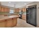 Kitchen features light wood cabinets, tile countertops, and black appliances at 1075 Burgoyne Rd, Deland, FL 32720