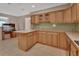 Kitchen features light wood cabinets, tile countertops, and modern appliances at 1075 Burgoyne Rd, Deland, FL 32720