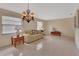 Bright living room with neutral tile flooring, multiple windows, and traditional furnishings at 1075 Burgoyne Rd, Deland, FL 32720