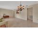 A bright living room features an elegant chandelier and neutral decor at 1075 Burgoyne Rd, Deland, FL 32720