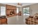 Living room featuring a brick fireplace, neutral tile flooring and a sliding glass door to the outside at 1075 Burgoyne Rd, Deland, FL 32720