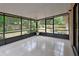 Enclosed back porch with tile floors and views of the backyard at 1075 Burgoyne Rd, Deland, FL 32720