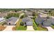 Aerial view of a home with mature trees, a manicured lawn, and a two-car garage at 11094 Se 173Rd Ln, Summerfield, FL 34491