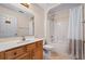 Bathroom featuring a neutral vanity, toilet, and shower with a curtain at 11094 Se 173Rd Ln, Summerfield, FL 34491