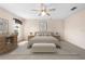 Bright bedroom featuring neutral tones, a ceiling fan, and a stylish decorative accent wall at 11094 Se 173Rd Ln, Summerfield, FL 34491