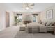 A bedroom with neutral carpet, ceiling fan, and closet view at 11094 Se 173Rd Ln, Summerfield, FL 34491