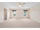 An empty bedroom with neutral carpet, ceiling fan, and closet view at 11094 Se 173Rd Ln, Summerfield, FL 34491