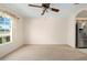 An empty dining room with a ceiling fan and large windows allows in natural light at 11094 Se 173Rd Ln, Summerfield, FL 34491