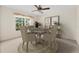 An updated dining room with neutral carpet, decor, and a window to let in natural light at 11094 Se 173Rd Ln, Summerfield, FL 34491