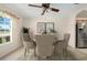 A dining room with neutral paint, a ceiling fan, and large windows allows in natural light at 11094 Se 173Rd Ln, Summerfield, FL 34491