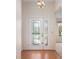 Inviting foyer with decorative glass door and hardwood flooring at 11094 Se 173Rd Ln, Summerfield, FL 34491