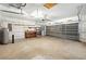 Spacious two car garage featuring an overhead door, workbench and shelving perfect for storage or projects at 11094 Se 173Rd Ln, Summerfield, FL 34491