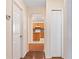 Hallway leading to kitchen with wood floors and neutral tones at 11094 Se 173Rd Ln, Summerfield, FL 34491