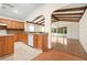 Charming kitchen features wood cabinets, a tile backsplash, and opens to a living room at 11094 Se 173Rd Ln, Summerfield, FL 34491