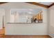View of the kitchen from the living room, features eat-in bar and stainless appliances at 11094 Se 173Rd Ln, Summerfield, FL 34491